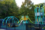 Some of the Kaleidoscope Playground facilities, including an accessible swing, zip line, see-saw and play equipment.